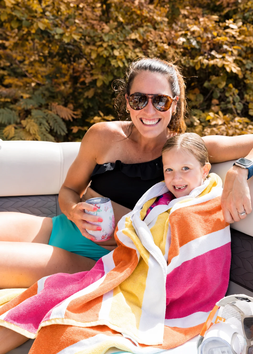 A mother and daughter smiling together on a fall afternoon.